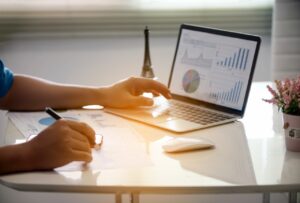 business professional reviewing payment data analytics and performance metrics on a laptop